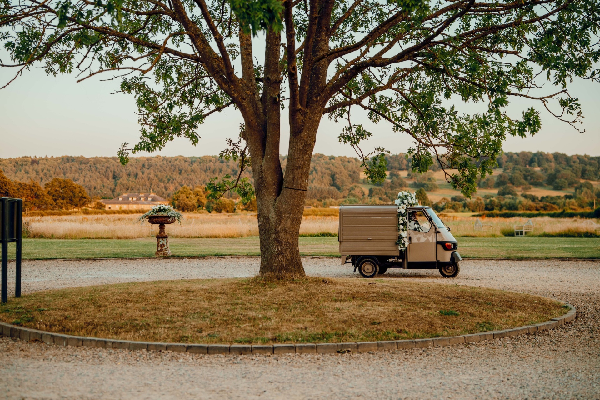 The mocca-coloured Ice Cream Tuk parked at a countryside wedding venue