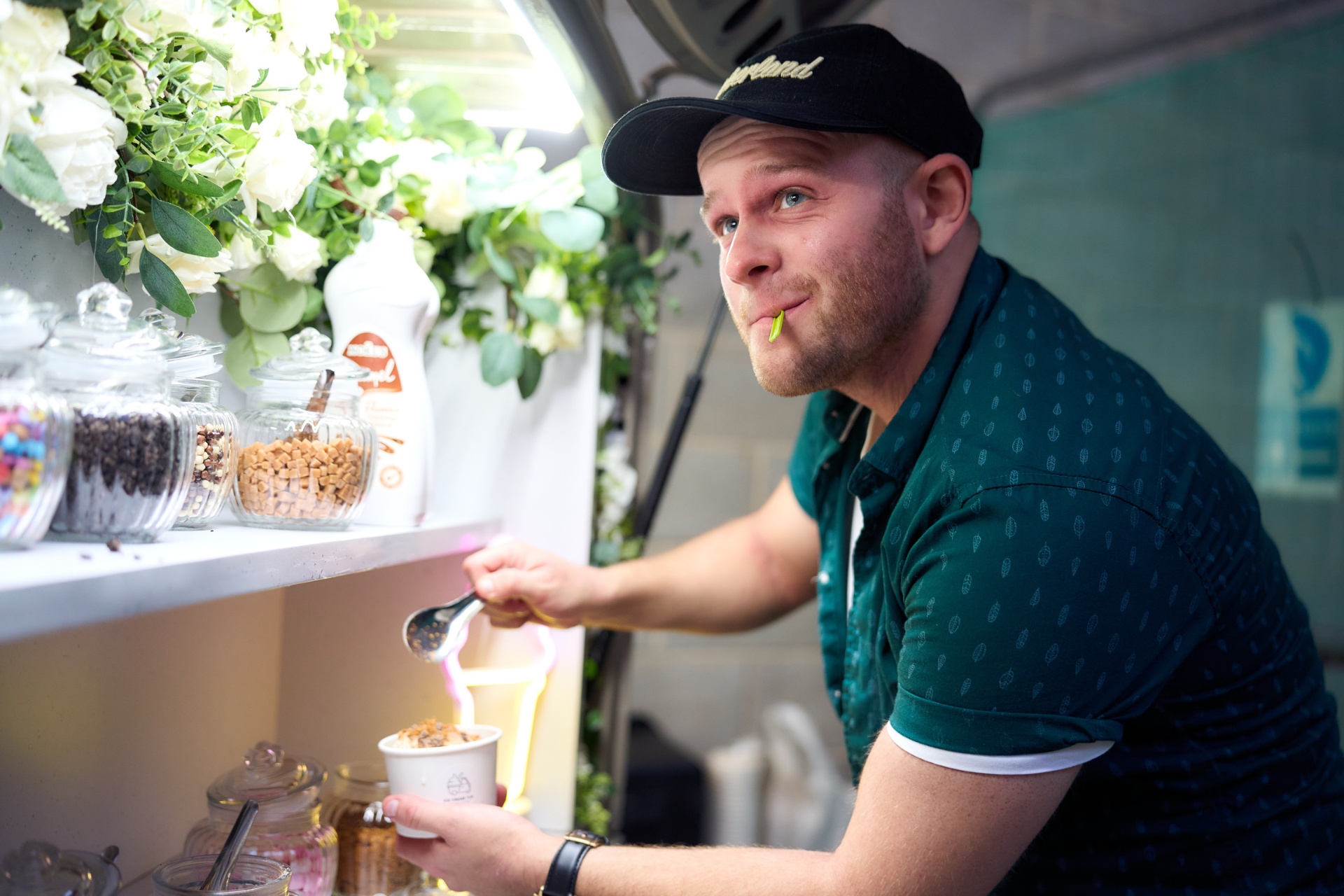 Server inside the tuk-tuk serving soft-serve ice cream
